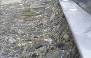 Eroded dam slab behind the protective layer